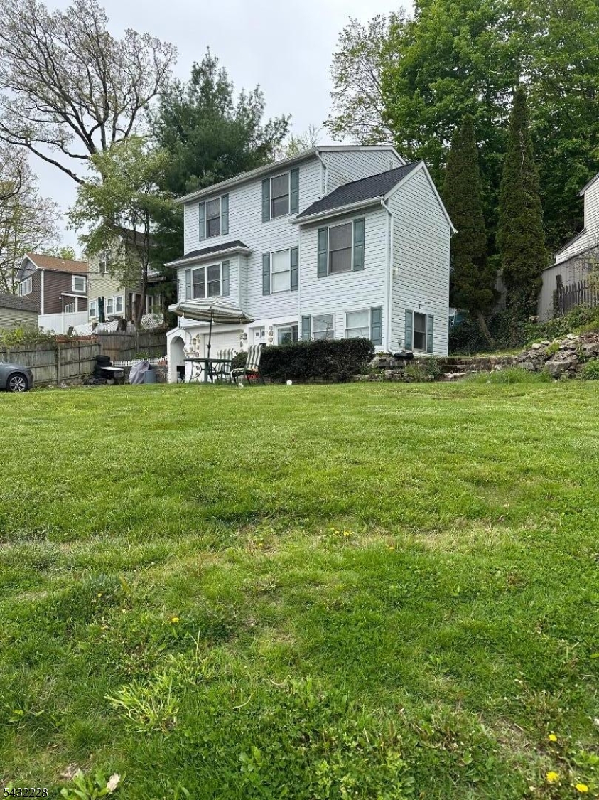 Multi-Family Residence located directly across from preserved town property which give this house a beautiful Lake view. Maximize your portfolio or live in one unit and rent the other unit for additional income. Large parking area for 7 or 8 cars. First level consists of Garage, Laundry, Kitchen, Second Level Living room, dining room, bonus room, and two bedrooms. Second Apartment is located on the third level which consists of 2 bedrooms, Deck.#1 Unit lease end on 8/31/26 #2 unit is month to month.This property can also be used as an Airbnb Most apply to the townhall for proper permits owners had previously rented as an Airbnb.