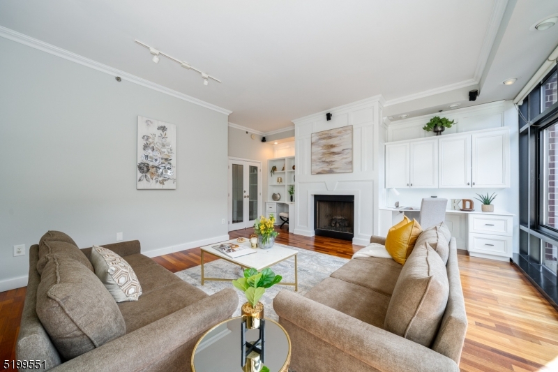 One of a kind Sky Club luxury duplex offers engaging floor plan & striking interiors. 3880 SF of gorgeous living space stretch over 5 beds, 4 baths, den, & 4 private outdoor spaces! 1 year of garage parking included. 1st floor features open living space w/ 10 ft ceilings & glass stairwell. Kitchen offers SS appliances, dish washer & center island w/ beverage fridge. Dining area encompasses a granite kitchenette, wine fridge, & large pantry, leading out to the balcony. Enjoy entertaining guests in your oversized living area complete w/ fireplace, custom built-ins, & immense natural sunlight. Enter into the first of the 2 large primary suites w/ 2 cedar walk in closets & another balcony. Ensuite bath with spacious shower, vanity area, heated floors & more. The stairway leads you to the 2nd floor where you will find an additional 4 beds, den, 2 baths, 2 balconies, washer/dryer room & kitchenette. The 2nd suite has decorative ceiling & fireplace w/ a balcony off the room. Be wowed by the gorgeous custom designed dressing room & a huge ensuite bathroom with jacuzzi tub, shower, double sinks & heated floors. Additional features in this home are: Hardwood floors, recess lighting throughout every room, floor to ceiling windows, custom closets/ built ins, Hunter Douglas shades, & tons of storage. The Sky Club features 24 hour concierge, shuttle to/from path, community room & bike storage. Near light rail, restaurants, shops, parks, schools and more.