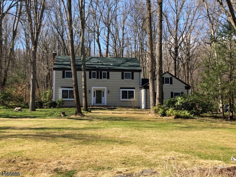 Nicely updated center hall colonial located in "The Valley".  Wooded lot w/stream offers privacy & tranquility. 1 Year old roof, large shed, System 2000 heating system, central air, thermal windows and large deck. Seller will be installing a brand new 4 bedroom septic system!  Hardwood floors throughout, wood burning fireplace in formal living room, kitchen with granite countertops, updated powder room, first floor laundry, master suite with French doors to balcony, 3 additional spacious bedrooms and attic storage.  Desirable Cucinella elementary school and top rated West Morris Central High School!