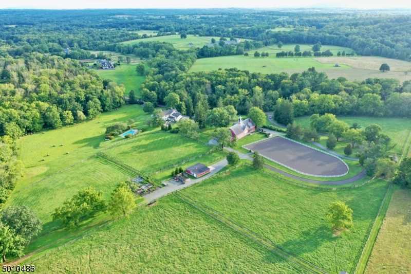 "Meadowbrook Farm" will impress you with its vast bucolic pastures & idyllic allure. Set on 24 ac of farm assessed property in the heart of Hunt Country, this restored farmhouse boasts authentic architectural details coupled with modern amenities for today's living. Two story 3 season porch, pool, walled bluestone patios, grilling island, & 2 outdoor fireplaces. Summer kitchen, carriage house w/ apt. Horse facilities include:11 stall historic horse barn w/ 2 apts, 3 stall pony barn w/ equip garage & full riding ring. Mature trees, specimen plantings, & the rambling middle brook complete this unique property.