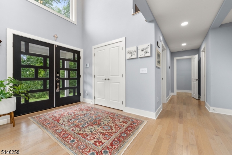 A long private driveway sets the stage for this exceptional custom Colonial, beautifully rebuilt in 2020 and nestled on 1.5 private acres. Set well back from the road, the home offers a rare sense of privacy while remaining just minutes from Warren Township's shopping, dining, parks, and major commuting routes. Offering over 4,200 sq. ft. of thoughtfully designed living space, this home features 5 spacious bedrooms and 4 full baths, including a desirable first-floor guest suite. Expansive windows fill the home with natural light, highlighting soaring ceilings, timeless finishes, and meticulous craftsmanship throughout. Tesla Charger inside the garage, 22 kW Generac generator covering the full house, including a/c + heating, entrance landscaping with lights on the driveway. A whole-house generator provides added peace of mind, while the home's thoughtful design offers the perfect balance of elegance, comfort, privacy, and everyday functionality.