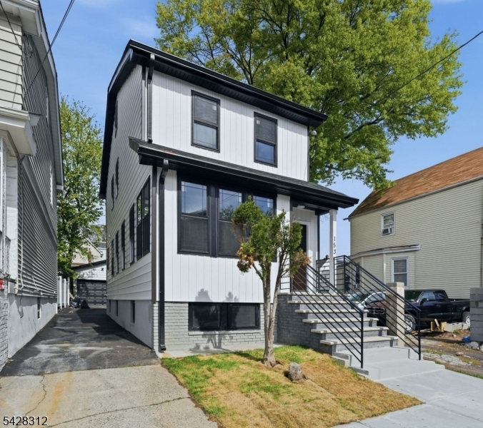 Stunning top notch modern single-family home offering 4 spacious bedrooms and 2.1 bathrooms, plus a finished attic and a fully finished basement. The first floor features a bright formal living room, an elegant dining area and a Beautifully designed kitchen featuring a center island with a built-in microwave space conveniently tucked underneath. sleek finishes and brand-new stainless steel appliances, along with direct access to a rear cozy deck.  A convenient powder room and an enclosed front porch provide ideal space for a home office, sitting area, or flexible use. The second floor along with the finished attic offers four generously sized bedrooms and a full bathroom, providing comfort and versatility. The finished basement showcases an open-concept layout, a full bathroom and a dedicated laundry area. This home is equipped with dual-zone central air and HVAC systems for efficient year-round comfort. The exterior features a private driveway, an oversized detached garage and a cozy deck ideal for entertaining and outdoor gatherings. Truly turn-key and move-in ready, conveniently located near NYC transportation, schools, shopping and more. A must-see home that offers the perfect blend of style, space, and functionality!