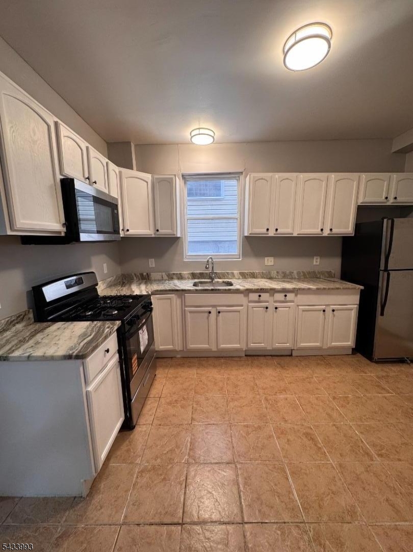 Welcome to this NEWLY UPDATED and SPACIOUS 3 bedroom/1.5 bath first floor apartment w/ in-unit laundry located in the heart of Newark! This unit features a bright and functional kitchen featuring ample wood cabinetry, sleek and shiny countertops, equipped with stainless steel appliances including a gas range and built-in microwave. The living room has a well-proportioned layout with a half bath for convenience, and it is very bright and inviting featuring beautifully refinished hardwood floors that add warmth and character. The neutral-toned walls create a clean, move-in-ready feel and provide the perfect backdrop for any decor. A large window fills the room with natural light, enhancing the open and airy atmosphere. Schedule your showing, it won't last!