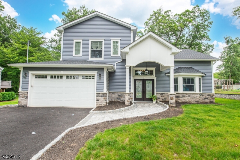 Stunning Custom-Built Home in Prime Livingston Location, this exquisite 5-bedroom home combines modern elegance with thoughtful design and high-end finishes throughout. Soaring ceilings and an open-concept layout on the main level create a bright and airy atmosphere, ideal for both everyday living and entertaining. The spacious first floor includes a grand entryway, formal living and dining areas, a cozy fireplace, and a gourmet chef's kitchen, double sinks. The kitchen features top-of-the-line stainless-steel appliances, designer cabinetry, quartz countertops, a custom range hood, oversized island, and sliding glass doors leading to a private patio and backyard perfect for indoor-outdoor living. Also on the main level is a guest bedroom with an en-suite bath and direct access to the attached 2-car garage. Upstairs, the luxurious primary suite features a tray ceiling, spa-like bath and dual vanities, and custom walk-in closets. Additional bedrooms, a full bathroom, and a convenient laundry room complete the second floor. Tesla Charger