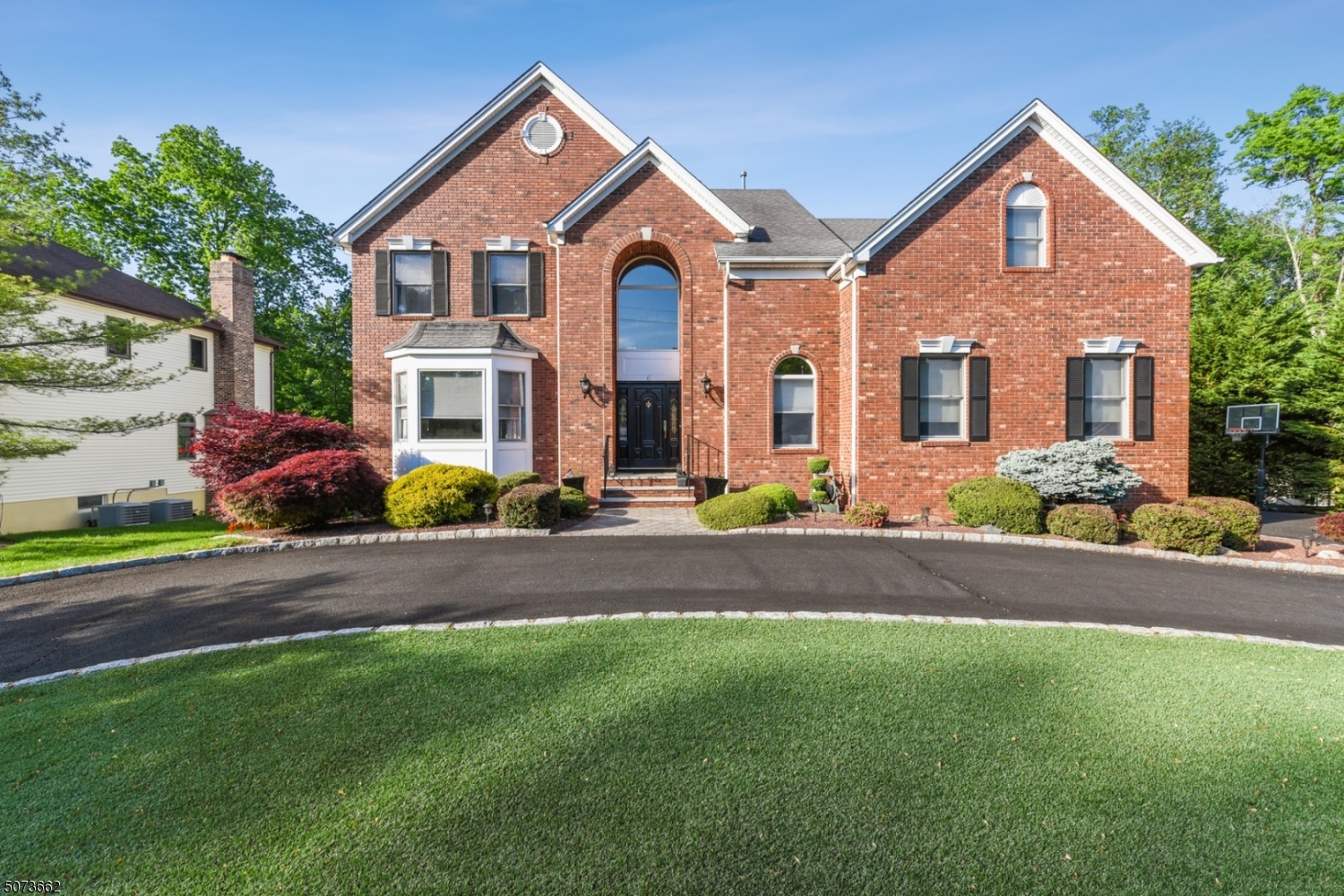 Gorgeous updated move-in ready brick colonial w/ circular driveway, close to shopping, restaurants & highways!  Tiled 2 story foyer leads to eat-in Kit w/ maple cab's, stnls appl's, island & granite. French door to deck. Open layout to sunkin FR w/ FP.  Formal DR, bright LR, and cozy office finish up 1st floor, all w/ HW floors. Upstairs leads to expansive master suite w/ HW floors, sitting area, 3 walk-in custom closets & beautifully updated ensuite bath.  3 more BR's (all w/ ceiling fans & plenty of closet space), full BA & laundry (so convenient!) round out 2nd floor. Huge finished bsmnt w/ in-law suite potential - large den/rec room, wet bar, BR, full BA & walkout slider to paver patio. Newer lighting fixures & crown molding throughout home. Fenced backyard, shed & stunning landscaping. Come see it today!