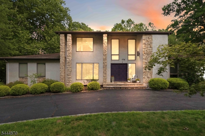 Welcome to 174 Brooklake Road, where timeless elegance meets tranquil living in one of Florham Park's most sought-after locations. Perfectly positioned between Florham Park and Madison, this exceptional home offers the best of both worlds?serene, unobstructed views of nature from the backyard and picturesque views overlooking the lush fairways of Brooklake Country Club from the front.This beautifully maintained residence features 4 spacious bedrooms, 3.5 baths, and an inviting open floor plan designed for both comfortable everyday living and effortless entertaining. Sun-filled living spaces flow seamlessly throughout the home, while the beautifully appointed kitchen opens to the main gathering areas, creating the perfect setting for hosting. The luxurious primary suite is a true retreat, offering two walk-in closets, a spa-like ensuite bath, and a private balcony where you can enjoy your morning coffee or unwind at the end of the day while taking in the peaceful natural surroundings. Situated on over an acre of beautifully landscaped property, the expansive deck and park-like grounds provide the ideal backdrop for entertaining, outdoor dining, or simply relaxing in complete privacy. Combining generous living space, breathtaking views, and an unbeatable location just minutes from shopping, dining, top-rated schools, and commuter routes, this remarkable home offers a rare opportunity to enjoy the very best of Florham Park living.