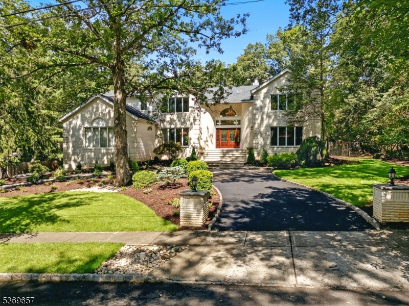 Custom-built by the owner, this elegant 5-bedroom residence is bathed in natural light with oversized windows throughout. A marble entryway with Schonbek crystal chandeliers and striking architectural moldings set the tone for the dramatic two-story foyer and great room. The gourmet kitchen features a Villeroy & Boch porcelain floor, expansive center island, Sub-Zero refrigerator, granite countertops, double ovens, trash compactor, and abundant storage perfect for both everyday living and entertaining. A dual fireplace connects the inviting family room to the great room, while French doors open to a sprawling deck ideal for gatherings. Upstairs, the princess suite offers its own private bath, complemented by two additional generously sized bedrooms. The luxurious primary suite impresses with two walk-in closets, a sitting room, and a spa-like marble bath with jetted tub and stall shower. A circular driveway framed by lush landscaping creates a stunning first impression, blending elegance with convenience. With the added potential to finish the first-floor bonus room and expansive basement, this home offers unmatched flexibility for today's lifestyle all on a quiet cul-de-sac.