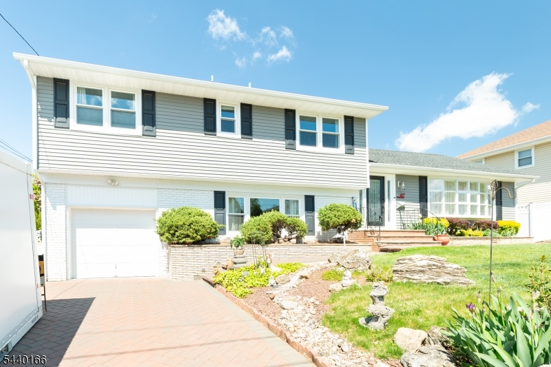 Stunning 3000+sqft 4 Bed/3.5 bath Split-level home on quiet dead-end street. Main level boasts complete open layout with large dining room open to chef's kitchen like you have never seen! Bone white cabinetry with dark gray quartz countertops, high end s/s appliances including 6 burner range and commercial exhaust hood. Huge island with white quartz counters and seating for 5 has attached matching table with additional seating. Separate bar area with more cabinetry and wine fridge. Tons of space for hosting any party in this home. Recessed and pendant lighting. LVP flooring throughout this level. Full bathroom with laundry. Upstairs HW floors throughout the bedrooms. Master bedroom with en-suite and French doors to adjacent 2nd bedroom, currently used as office. 2 closets, including huge cedar walk-in. 2 more good sized bedrooms and full common bath including fully tiled shower with white subway tile, mosaic accent tile, niche and dual shower heads. Ground level has family room with crown molding, recessed lights, wet bar and powder room and french doors to the expansive Florida room with 3 walls of windows, heated by electric baseboard and cooled with AC split system. Partial basement with tons of storage and utilities including brand new water heater and 2022 3-zone Weil McLain boiler. 200 amp upgraded panel. Roof, siding and windows 2020. Backyard retreat includes multi-level patio with flagstone walkways. Paver driveway, attached garage. 1.1miles to Metuchen train station
