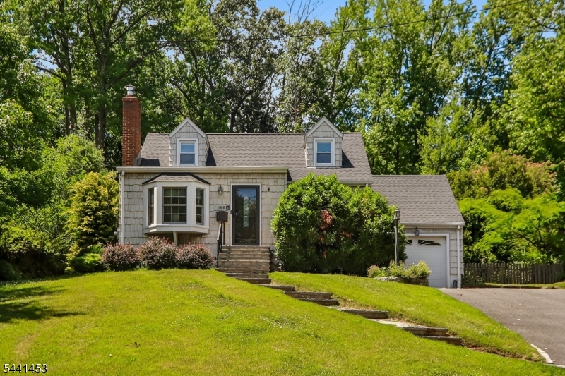 Welcome to your own private retreat in the heart of Scotch Plains! Set on a beautifully landscaped .39-acre property, this charming 3-bedroom, 2-bath home offers comfort, character, and convenience.Enjoy a peaceful, park-like backyard with mature trees, a cozy firepit, expansive green space, and a spacious deck perfect for entertaining, outdoor dining, or simply relaxing. Inside, you'll find a welcoming living room with a gas fireplace, formal dining room, and an updated kitchen featuring white cabinetry, granite countertops, and stainless steel appliances.The first-floor primary bedroom offers easy living and includes a large dressing room/walk-in closet, while a versatile den is ideal for a home office, playroom, or reading nook. Upstairs are two generously sized bedrooms and a beautifully remodeled full bath.The fully renovated lower level provides additional living space with a family room, workshop, laundry room, and abundant storage.Ideally located near top-rated Scotch Plains schools, downtown shops and restaurants, and recreation, this home also offers convenient access to NYC transportation for an easy commute.A rare opportunity to enjoy privacy, space, and an exceptional lifestyle in one of Scotch Plains' most desirable locations.