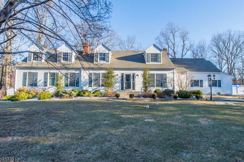 Rare Find! Beautifully renovated and updated colonial with full inlaw suite with separate entrance. Gorgeous wood floors throughout; open concept layout; chef's kitchen with granite and stainless; great master suite with tiger wood floor, attached full bath & walk-in closet; sizeable secondary bedrooms; nicely updated main bath and powder room. 1st Floor Inlaw suite boasts bedroom, full bath, kitchen, living room with sliding door to deck and private entrance.  Partially finished basement offers great potential as evidenced in the finished office space. 1.84 level acres with in ground pool, patio and deck. Barn with electric is an added plus! 2 car attached garage. Roof and windows less than 10yrs old. On the south side of the 'Valley' - perfect for 78/287 commuter. Top-rated West Morris School district.