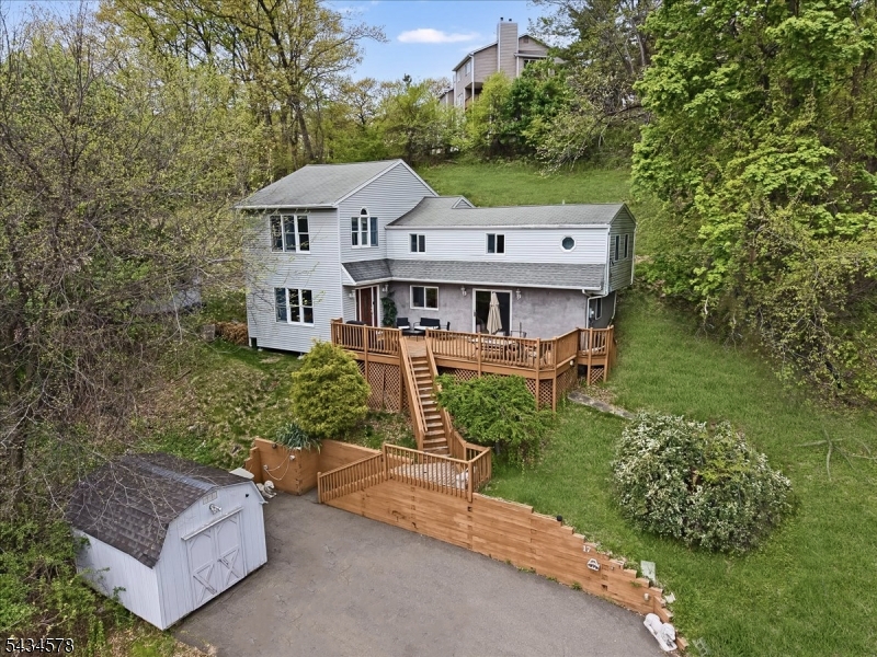 3 Bedroom and 2 Bathroom Home with Oversized Bedrooms, Private Primary Suite & Peaceful Dead-End LocationSet on an elevated lot at the end of a quiet street, this 3-bedroom, 2-bath home offers a rare combination of privacy, natural light, and generously sized rooms a standout in today's market. The unique hillside layout creates a bright, open feel with larger-than-average bedrooms, including a spacious primary suite featuring a private bath with jacuzzi tub, separate shower, and convenient in-room laundry. The main level includes a full bathroom with stand-up shower and flexible living space, while multiple outdoor areas enhance everyday living. Enjoy a front deck for entertaining, a secondary deck off the primary bedroom, and a rear area with future potential. Two storage sheds provide practical space in place of a traditional basement. Major upgrades include a new central heating and cooling system (approx. 2 years old), plus supplemental electric heating panels. All appliances including washer/dryer are included. A private driveway ensures easy parking. Located just minutes from major highways, shopping, restaurants, and within walking distance to a top-rated tech school, this home delivers the perfect balance of convenience and a quiet, tucked-away setting.