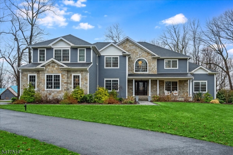 This 5,300-square-foot residence in a premier Brookside, cul-de-sac neighborhood offers a rare opportunity for newer construction on 2.26 gated acres. Enhanced far beyond its 2020 origins, this five-bedroom estate provides a fully self-sustaining, turn-key lifestyle. The open-plan layout features a gourmet kitchen with JennAir appliances opening to the breakfast area and the 2-story great room with a gas fireplace and back staircase. The first floor also includes formal living and dining rooms, a private office, a conservatory/family room with a gas fireplace, and a full guest suite. The primary wing is a true sanctuary, featuring a sitting room with a two-sided fireplace, a spa-caliber bath with radiant flooring, and expansive walk-in closets. The lower level serves as a professional entertainment hub with a media room, exercise area, rec room, and full bath. Outside, the grounds are a private oasis with stunning views featuring a heated saltwater pool with a 40-foot stone patio, a regulation basketball court, and integrated irrigation. Engineered for uninterrupted comfort, the property includes a commercial-grade Generac generator supporting the entire estate. The water system was modernized in 2024/25 with a new well pump and holding tank for peak reliability. Complete with a finished heated four-car garage and a fabulous mudroom. With easy access to NYC transit and 35 minutes to Newark Airport. Highest and best offers due Wednesday, 4/1 at 12:00.