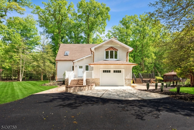 Welcome to this stunning custom renovated contemporary estate situated on over 3 acres with highly sought-after South Brunswick schools. Redesigned with high-end finishes and exceptional craftsmanship throughout, this one-of-a-kind property offers the perfect blend of luxury, privacy, and modern functionality. The custom kitchen opens seamlessly into the main living area and features quality hardwood cabinetry, farmhouse sink, oversized Taj Mahal quartz island, and premium finishes throughout. Interior upgrades include extensive custom wainscoting, designer lighting, updated flooring, spa-inspired bathrooms with freestanding vanities and under-lighting, illuminated niches, and a luxurious primary suite. Additional finished living space includes a family room and finished basement ideal for recreation, gym, office, or media use. Exterior improvements are equally impressive and include new vinyl vertical siding with shake accents, updated hardscape, new paver patio, front entry patio, exterior soffit lighting, expansive driveway, and beautifully landscaped lush grounds offering a true estate/retreat setting. A standout feature of the property is the detached 1200+ sq. ft. two-car garage with finished loft space above, offering endless possibilities for studio, office, gym, storage, or workshop. Additional major upgrades include a high-end septic system, updated exterior finishes, deck, and numerous custom details throughout the property.