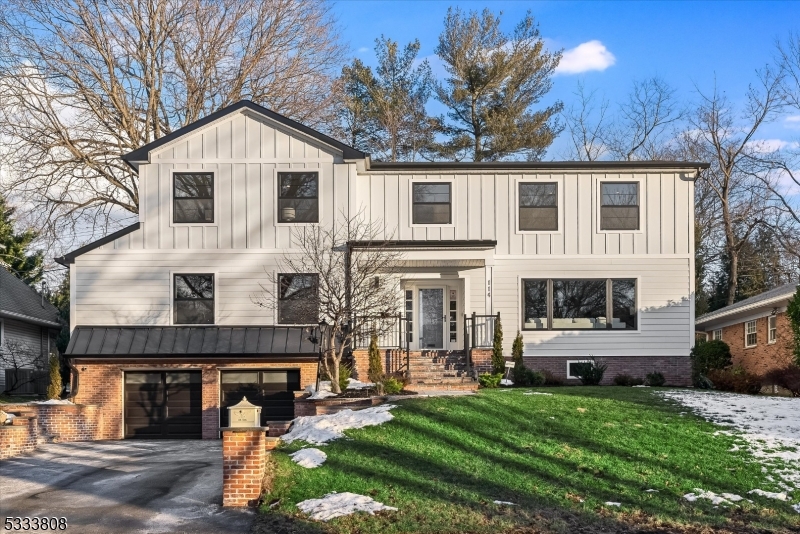 Welcome to 114 Yantacaw Brook Rd! This stunning, newly renovated contemporary home blends sleek design with high-end finishes for the ultimate in luxury living. Upon entry, you're greeted by a light-filled, open-concept family room featuring a modern electric fireplace, creating the perfect space to relax and unwind. The chef's kitchen boasts top-of-the-line stainless steel appliances, a walk-in pantry, custom cabinetry, and elegant quartz countertops. The living room features a custom accent wall that adds a touch of sophistication. Adjacent is a spacious office/guest bedroom and chic powder room. The formal dining room includes a large wine refrigerator and wet bar- ideal for entertaining. Just off the kitchen, a sunroom offers peaceful views of the beautifully landscaped backyard, complete with a large patio and tiered wall. Upstairs, the spectacular primary suite features a walk-in dressing room and a luxurious bathroom with a soaking tub and double vanity. Two additional bedrooms with large closets, a stylish main bathroom, and a spacious laundry room complete the second floor. The finished basement offers a custom gym, full bathroom, additional laundry, and extra storage. The two-car garage with a decorative epoxied floor adds both style and function. Conveniently located near Yantacaw and Brookdale parks, this hidden gem is close to NYC transport and highways, this home is the perfect blend of luxury and convenience. The only thing better? Making it yours!