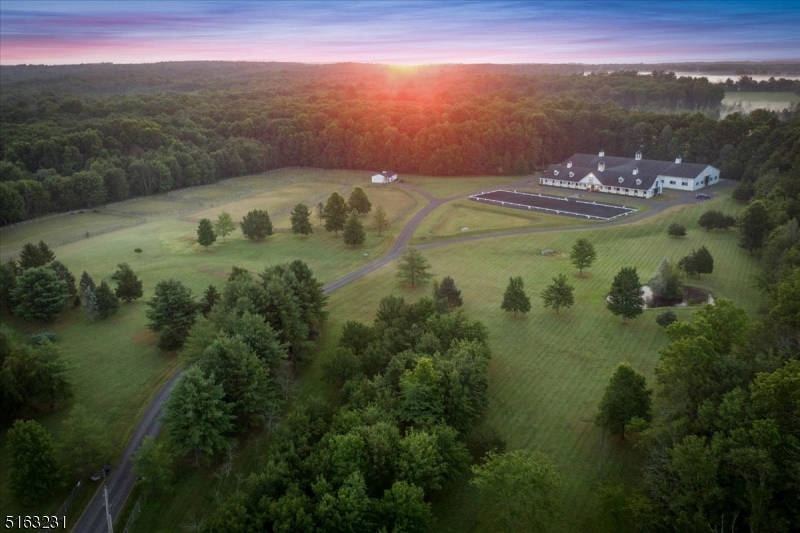 Welcome to Windy Oak Farm. This magnificent equine property is centered in a bucolic landscape & filled with state of the art, chic amenities. A King constructed commercial facility boasts a designer appeal for the most discerning clientele. Set on 24+ private acres the stable is adorned with 6 cupolas, 20 box stalls with European Loddon stall fronts, each with exterior window, 2 wash stalls, 2 grooming stalls & drive up farrier/vet bay. Year round functionality is seamless with the heated private office, feed room, laundry, tack & Observation room. Multiple spaces for owners and guests to relax, be entertained & enjoy their equine experience. You will feel embraced and inspired by your surroundings built for the human & equine athlete. The newly renovated observation room features a gorgeous kitchenette, heat and A/C. The indoor arena has been upgraded to enhance the beauty & magnitude of this amazing space. The exterior of the property offers the 100x200 outdoor arena, storage barn, 8 grass paddocks, natural pond & courtyards for gathering or relaxing to the sounds of happy horses.  A 4 bedroom septic is in place to complete your dream estate by building a custom home on this exceptional property. Minutes from 78 all within 1 Hour of NYC.  Ready to serve as a year round home or seasonal base camp this facility has successfully served both dressage & hunter jumper trainers at the top of their profession. Property under video surveillance & equipped with Starlink internet.