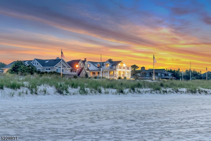 Indulge in the epitome of luxury oceanfront living at Crescent Park, New Jersey's prestigious enclave. This prime Jersey Shore location offers a rare blend of oceanfront property w/ panoramic unrestricted ocean views, beautiful sandy beaches, and a serene 17-acre maritime forest backdrop. Wake up to the soothing symphony of waves and immerse yourself in the tranquility of nature on the Atlantic Ocean, while still being moments from downtown's vibrant scene. Crescent Park is renowned for its exclusivity, with only 21 opulent homes. Only 2 of these homes have been offered for sale in the last decade! Seize this extraordinary opportunity to own a home in one of the most sought-after locations - a breathtaking three-story architectural marvel spanning over 6000 sq ft, with ocean views from every room. This exceptional property features 6 bedrooms w/ private balconies, 5 full bathrooms, and 3 half-baths. Situated near renowned private and public schools, it presents an ideal setting for buyers seeking a perfect balance of education and coastal living. Addtl features include a charming carriage house, oversized garage w/ room for your golf cart, elevator, finished basement, wine cellar, sauna, gym, 2 laundry rooms, and enchanting rose gardens. Preview this remarkable location where luxury and coastal living converge, & be inspired by the endless possibilities that await. This once-in-a-lifetime property invites you to make it your own, a true sanctuary for luxurious coastal living.