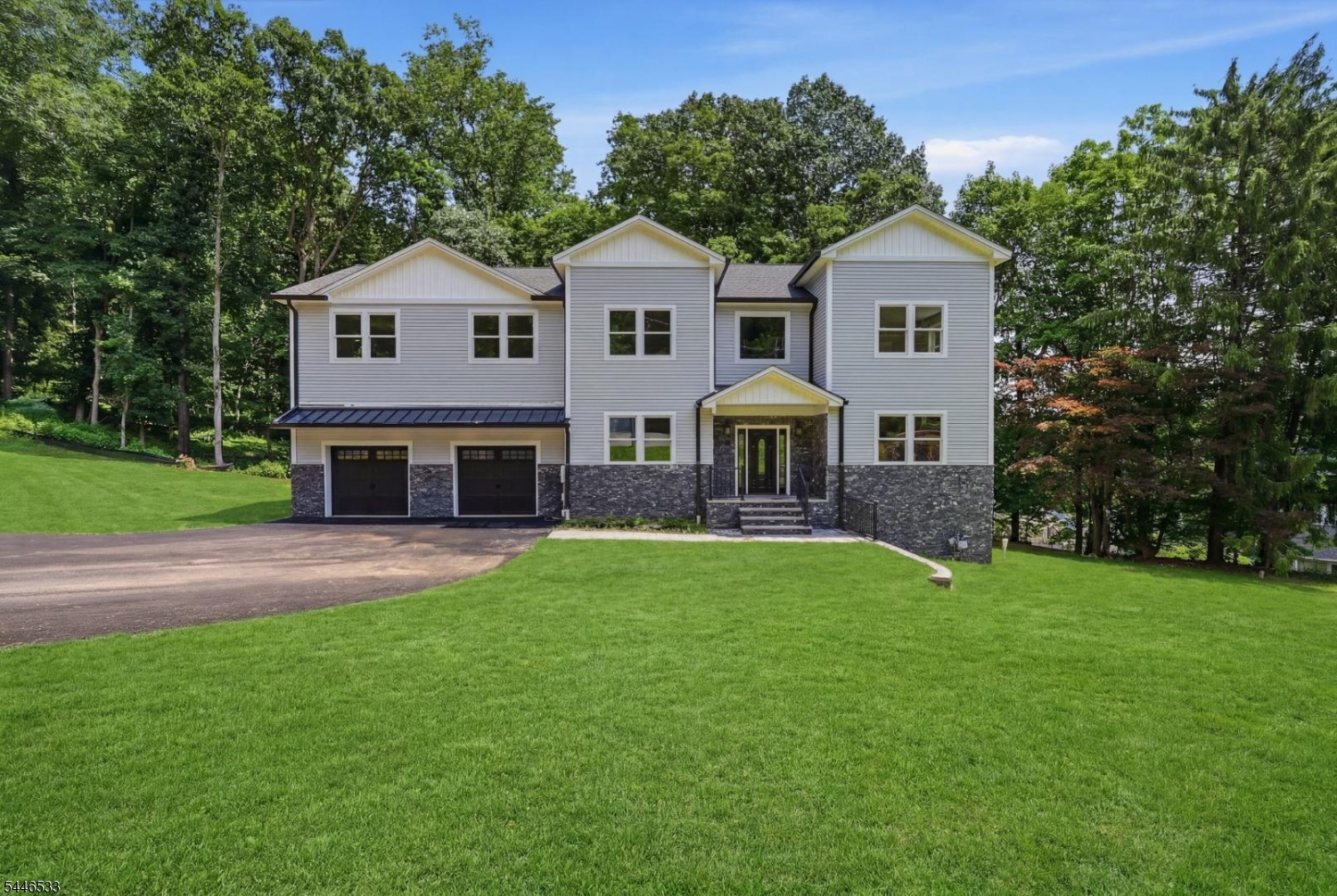 Stunning brand new custom colonial in sought-after Morris Township, completed in 2026 and never lived in. This 5 bedroom, 5 full bath home offers approximately 3,500 square feet of bright, thoughtfully designed living space on nearly half an acre backing to the woods. The gourmet kitchen features white shaker cabinetry, quartz countertops with a full-height quartz backsplash, a farmhouse sink, brass fixtures, a built-in desk nook, and a full Samsung stainless appliance package, all flowing into an open living area anchored by a huge composite deck overlooking the trees. A custom mudroom with built-in cubbies sits right off the kitchen. Upstairs, the primary suite impresses with a walk-in closet with custom organizers and a spa bath featuring a freestanding soaking tub, an oversized rain shower with brass fixtures, and dual LED-lit vanities. Every bathroom in the home is a fully tiled full bath, a rare find. The finished lower level adds enormous flexible space for a rec room, gym, or media room. Natural oak hardwood floors, recessed lighting, and New Home Warranty complete the package. All this just steps from the park, ball fields, and pond, and minutes to downtown Morristown and NYC train service. Why wait to build when it's already done?