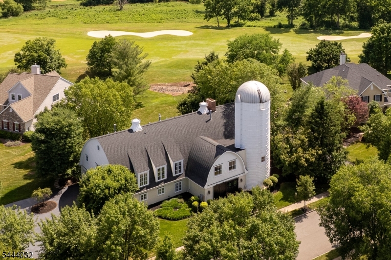 Just minutes from downtown Princeton, this extraordinary custom home showcases breathtaking panoramic golf course views of Cherry Valley and a remarkable blend of timeless architecture and effortless modern living. Reimagined in 2003 by renowned architect Max Hayden, this exceptional residence?the crown jewel of Cherry Valley?makes a striking first impression with its iconic white two-story silo and handsome sliding door. Seamlessly incorporated into the home's design, the distinctive silo features a beautifully appointed powder room, private home gym, and spacious walk-in closets. Beyond the front door, soaring spaces, exquisite millwork, and rich Brazilian walnut floors create an immediate sense of elegance. A dramatic balcony, barrel-vaulted ceilings, and walls of windows fill the home with natural light and an extraordinary sense of volume. Designed for effortless entertaining, gracious gathering spaces flow into a spectacular chef's kitchen featuring an oversized center island, custom cabinetry, an expansive breakfast area, large pantry, and premium finishes. The second level with twelve-foot ceilings offers five spacious bedrooms with walk-in closets and en-suite bath access, including a luxurious primary suite with a sitting room, fireplace, spa-inspired bath, expansive dressing area, and exercise studio within the iconic silo. An oversized bonus room, unfinished third floor, and oversized three-car garage complete one of Cherry Valley's most distinctive residences.