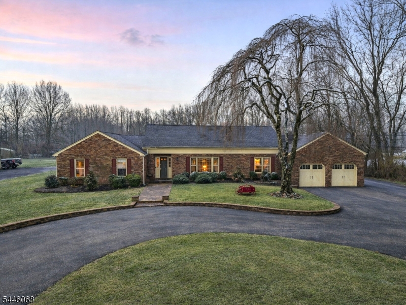 Great opportunity to own over 3/4 of an acre in sought after Northern Manalapan with approximately 2,800 sqft Ranch Home. Zoned LB-T for future possibilities. Priced to Sell. Over-sized circular driveway. 1st floor with amazing character, 4 bedrooms & 2 full baths. Primary suite with private full bath. 2nd floor loft overlooking family room with wood burning fireplace, cathedral ceilings leading to 4th bedroom, perfect for guests or home office. Enjoy entertaining in the beautiful large kitchen with granite countertops and eat-in area, complemented by a formal dining room, sun-room, living room & convenient mudroom with access to large two car garage. Spacious backyard featuring a deck & in-ground pool. Estate Sale, No Repairs to Be Made. Original Septic System, Last Pumped 04/2026 Buyer to Obtain CO.