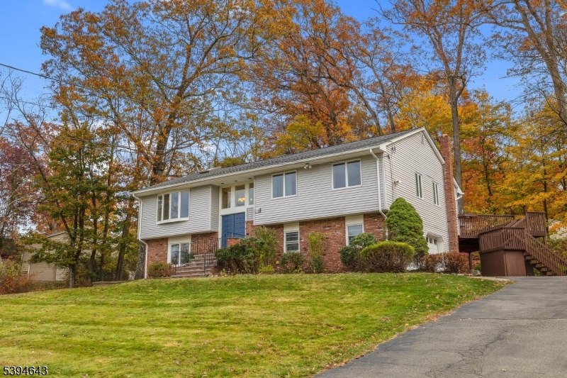 Welcome to 16 Dogwood Trail  -   a spacious 5-bedroom, 3-bath home blending comfort, natural light, and modern updates in a tranquil Randolph setting. The heart of the home is the enormous Great Room, featuring a focal fireplace, skylights and floor-to-ceiling windows offering sweeping views of the private, wooded backyard. A pair of sliders open to an expansive deck, perfect for entertaining or simply relaxing among nature. The chef's kitchen on the main, boasts abundant cabinetry, a breakfast bar, and flows seamlessly into a formal dining room ideal for gatherings.Also on the main level, the home offers three generously sized bedrooms and two full baths, while the ground level provides an amazing entertainment room, two additional bedrooms, a full bath, and a convenient laundry room  along with access to the two-car garage. Freshly painted Great Room, new roof, multi-zone hot water baseboard heat, and central air ensure year-round comfort. Set on a quiet street within walking distance to Hedden County Park, and just minutes from the Randolph YMCA, train station, and top-rated Randolph School System. Enjoy privacy, convenience, and an ideal location - all wrapped in a home designed for everyday living and memorable moments.