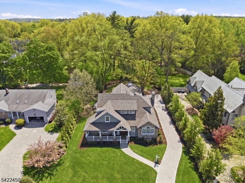 Experience effortless luxury in this stunning home built in 2023. A perfect blend of thoughtful design and exceptional top of the line finishings, this stunning residence with 9 foot ceilings offers 4 bedrooms, 4 full baths, and 1 half bath. The first floor primary suite is a true retreat, featuring dual walk in closets and a spa inspired bath with double vanities, soaking tub, and shower creating a serene escape. At the heart of the home is the chef's kitchen with gas fireplace, quartz countertops, dual wall Wolf ovens, Wolf 6 burner cook top, 48" Sub-Zero fridge  wine cooler, Miele dishwasher, fridge drawers and walk in pantry. This kitchen seamlessly flows into the breakfast room and family room with a gas fireplace perfect for both intimate gatherings and entertaining. This main level designed for convenience and ease also offers a living room with fireplace, office, mudroom, laundry room, powder room and an elevator for effortless access between floors. Upstairs, three generously sized bedrooms and two well appointed baths provide comfortable accommodations. The expansive lower level offers a full bath and endless possibilities for recreation, fitness, or additional living space. Set on .49 private acres, the outdoor space is equally appealing with a welcoming front porch, spacious deck, and lovely curb appeal. Also a three car heated garage, heated driveway, plenty of storage, cedar closet, 3 fireplaces, security system and so much more.  Enjoy this impeccable home!
