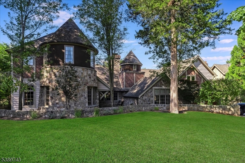 Exquisite Luxury Lakefront home.  A rare opportunity to own a premier residence on a private island home to only 34 beautiful lakefront properties. This 5 BR 6.1 BA estate like masterpiece is packed with exceptional quality and timeless design.  Set on a sweeping lawn with a large lakefront patio, this home delivers upscale lake living and privacy with its resort style pool, cabana and new boathouse offering direct access to lake adventures. Entertain in style with a new gourmet kitchen featuring a wood burning stone fireplace and french doors that lead out to your outdoor cooking station complete with cooking fireplace and inviting patios.  Retreat to the second floor primary suite equipped with a full bath, walk in closet, stone fireplace, sitting room with a covered porch to take in lake views. Spacious second floor office wing with a private bath and separate entrance providing a comfortable and substantial work environment.  Greet your guests with a unique bar room off the foyer then step into the rustic living enjoying wonderful lake views and gather around a cozy fireplace. The finished basement includes an exercise room, full bath with a seam room and wine storage. A lifestyle unmatched just an hour from Manhattan.