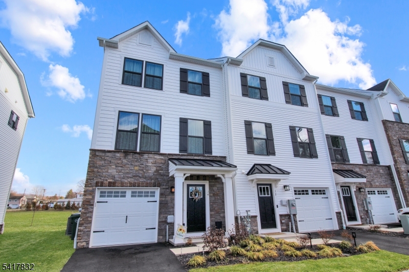 Welcome home to this stunning, nearly new townhome offering the perfect blend of vibrant downtown living and peaceful outdoor retreat. Backing to several acres of open space, this three-level home provides a rare opportunity to enjoy serene views from your private deck perfect for morning coffee or unwinding at the end of the day. The ground level features a spacious family room with walkout access to the backyard, a convenient powder room, and direct entry to the garage ideal for both everyday living and entertaining. On the main level, you'll find an open-concept layout highlighted by a beautifully appointed kitchen with a large center island, quartz countertops, and a custom upgraded backsplash. The kitchen flows seamlessly into an expansive living room and offers direct access to the rear deck, creating the perfect space for indoor-outdoor living. Upstairs, the home offers three generously sized bedrooms, a full hall bath, and a luxurious primary suite complete with a spa-like bathroom featuring a dual showerhead stall shower. Only two years young, this home is loaded with upgrades, including soft-close cabinetry, upgraded flooring, additional windows, high end washer/dryer, and stylish lighting throughout with dimmer controls - no detail was overlooked. Enjoy the convenience of being just a short walk to the train station, local restaurants, breweries, and Warren County's first distillery. Take a look today!!