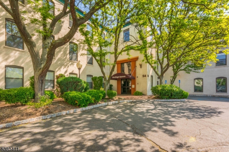 Welcome to this beautifully renovated two-bedroom condo, perfectly situated in the heart of downtown Rahway. Just steps from the train station with direct access to New York City, this home offers the ultimate convenience for commuters and city lovers alike. The inviting living room features a custom brick accent wall and plenty of natural light from oversized windows. A separate dining area, currently being used as a home office, adds versatility to the layout. The modern open kitchen boasts brand-new cabinets, granite countertops, and a stylish breakfast bar, making it both functional and welcoming. High ceilings throughout enhance the bright and airy atmosphere. Located on the ground floor, this condo offers two generously sized bedrooms and a fully renovated bathroom. Enjoy the comfort of central air and heating year-round plus laundry in unit. One assigned parking space is included for your convenience. With easy access to Rahway's vibrant downtown, you'll find a variety of restaurants, shops, and entertainment just around the corner. Don't miss this move-in ready home in a prime location!