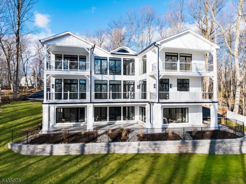 This completely rebuilt custom colonial offers an unparalleled combination of modern sophistication and timeless design. This home combines the serenity of a mountain retreat with the high end finishes of a NYC penthouse. A double-height entry hall welcomes guests with striking double glass and steel front doors The residence is framed by a sweeping circular drive 3 car garage and professional landscaping Reconstructed from the ground up, the home features expansive living spaces. Every bedroom in this home includes its own en-suite bath for total comfort and privacy A designer kitchen featuring a large center island with high-end cabinetry. The kitchen is equipped for the serious chef with premium stainless steel appliances, stone countertops and access to back/butlers pantry. The primary suite is a wing unto itself with 2 primary walk in closets and an expansive bathroom retreat with multi head rain shower and heated floors. This home also boasts multiple decks for sunset views and indoor and outdoor living. Not to be missed is the lower level with gym, recreation room with wet bar, and ensuite bedroom with direct access to the covered patio and backyard. Watchung offers a top tier school system Minutes from major highways like routes 78 or 22 and convenient to shopping and transportation to NYC. Watchung has a "mountain town" feel with only being 30 minutes from NYC.