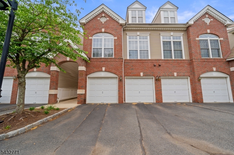 Bright, spacious and ideally located townhouse, just minutes from NYC transportation, major highways, shopping, schools, and local restaurants.This beautifully maintained 2-bedroom, 2.5-bath home boasts an open floor concept with high ceilings and oversized windows that fill the space with an abundance of natural light. The first floor features a spacious living and dining room combination with a cozy gas fireplace and sliding doors leading to a private patio overlooking peaceful green space. The modern kitchen offers a breakfast bar, ample cabinetry, and great functionality for everyday living and entertaining. A powder room, convenient laundry/utility room, and direct access to large garage complete the main level.The second floor features a spacious primary suite with a private full bath with double vanity, stall shower, jetted tub, and a walk-in closet. Enjoy your morning coffee or relax  in the evening on the private balcony off the primary suite. A generously sized second bedroom and an additional full bath complete the upper level.Additional highlights include new central A/C, new hot water heater, one car garage and plenty of parking. Enjoy outstanding community amenities including an outdoor swimming pool, tennis courts, clubhouse, and walking/jogging trails exclusively for residents.Perfect for owner occupied or investment!