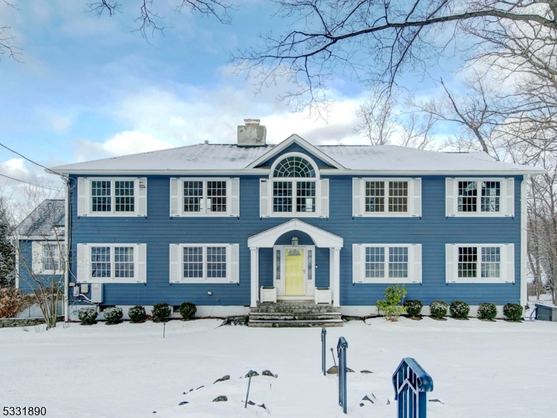 Fabulous colonial nestled in the highly sought-after Wickham Woods neighborhood! This beautiful home features a first-floor office and a bedroom with a private en-suite, providing both convenience and comfort. The kitchen features SS appliances, an oversized sink, quartz countertops, and two dishwashers. The eat-in kitchen opens to a bright sunroom, perfect for enjoying natural light year-round, and also features a cozy wood-burning fireplace for added charm. The 2 story entryway is illuminated by a custom chandelier, while elegant wainscoting adds a touch of sophistication to the first floor design. The second floor features 5 bedrooms and 5 full baths, including a newly renovated primary en-suite equipped with radiant floor heating. Conveniently, the laundry room is also located on the second floor. The finished basement expands the home's living space, featuring a rec room, bonus room, full bathroom and two separate walkout access points. One of these provides flexibility for a private entrance, making it perfect for guests or second home office. For added peace of mind the home is equipped with a full house generator, ensuring comfort and reliability in any situation. This home boasts amazing curb appeal with updated Hardie Plank siding. Relax and take in sunset views from the newer Trex deck, then head down the lighted stairs to the charming portico and tiered backyard. The beautifully designed space leads to a level grassy play area, perfect for outdoor enjoyment.