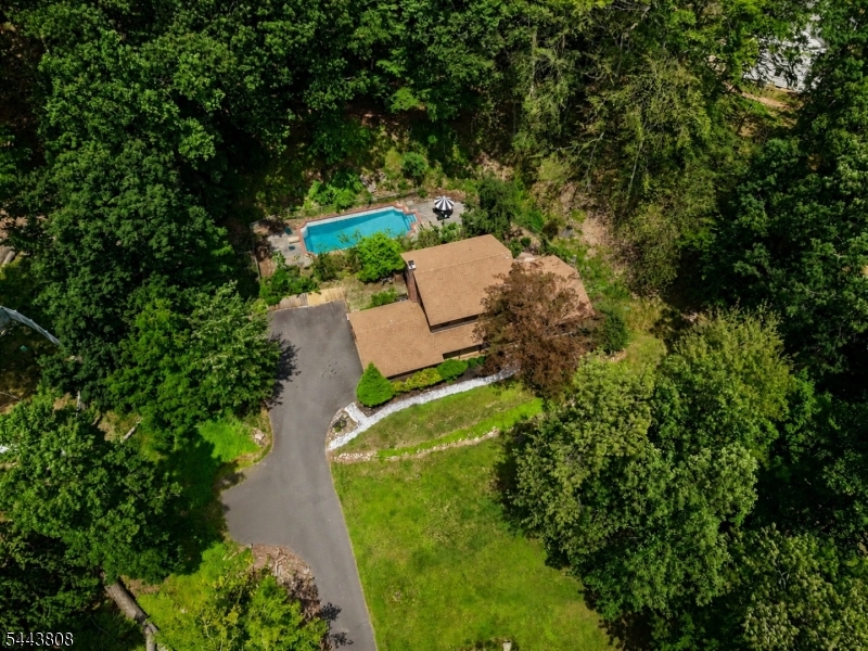 PRIVATELY SET on 1.17 acres of idyllic grounds amidst country estates and wooded splendor, this stunning 9 Room center hall colonial offers the perfect YEAR-ROUND RETREAT. Summertime fun is yours to enjoy as you entertain on the pool-side bluestone patio & take a swim in the fabulous 20 x 40 inground Gunite pool or relax with a good book and glass of wine on the covered front porch. The spacious first floor of this 4 BR, 2.5 BA home features a grand Living Room with sweeping views of the expansive front lawn, Adjoining Dining Room with French doors to a private patio, EIK with cherry finished solid wood cabinetry, solid surface counters, tiled backsplash & stainless-steel appliances, Generously sized Family Room with raised hearth FP, large Study/potential 5th BR with built-in bookcase, Laundry & Powder Room. Upstairs, the luxurious Master Bedroom includes an updated modern en-suite bath with vessel sink, custom tiled roman shower & lighted mirror! Special features include hardwood flooring throughout most rooms, custom upgraded lighting, energy efficient Pella windows & Kohler whole-house automatic generator! Additional updates include new hot water heater, W & D, roof (2018), well pump (2021), sump pump (2020) & whole-house filtration system. There's also a full basement and 2-car attached garage. Raritan Township's award-winning Blue-Ribbon school district is an added bonus! Inside and out, this home checks off all the boxes!