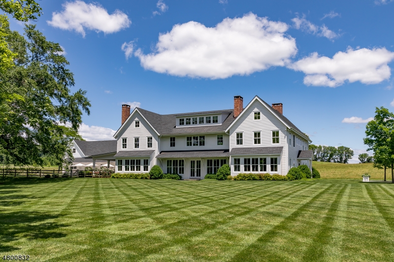 Meadowbrook Farm, an extraordinary working farm dating to the 1700s. Privately nestled on 124 acres of unsurpassed beauty, the 2012 custom home offers exceptional architectural design and detailing. Four finished levels w/ exceptional quality. HardiPlank siding, wide-plank Cyprus floors, expansive windows, high ceilings, marble surfaces, en suite baths, 3 fireplaces. Beautiful pool w/ limestone deck, changing room. Adjacent covered porch w/ automatic screens, outdoor kitchen. Radiant heat, elevator. Approx. 10,000'  climate-controlled barn, 6 stalls, 1/2 bath & unfin. space for future caretaker. Storage & equipment buildings. Gated entrance, gently rolling hills, open fields, sweeping views, pond, stands of hardwood & evergreen trees. 1/2 mile from Oldwick Village, 35 miles to Newark Airport, 48 miles to NYC