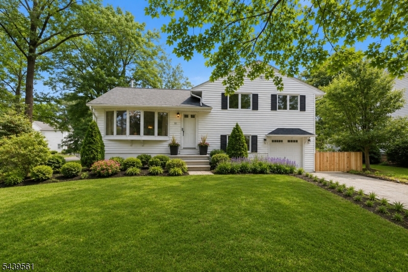 Welcome to 10 Cornell Place in Chatham, an updated and well maintained split-level home situated on a corner lot on a quiet residential street, just moments from downtown Chatham.  Hardwood floors extend throughout the main living and bedroom levels, complementing the bright, open floor plan. The spacious living room features a bay window that fills the space with natural light and a functional wood-burning stove. The living room flows seamlessly into the dining room and updated, functional eat-in kitchen, featuring ample cabinetry, generous counter space, and a practical layout.  Upstairs, the primary bedroom features an updated en-suite bathroom, while two additional bedrooms share an updated hall bath. The ground level includes an oversized family room with new laminate flooring, along with a mudroom, half bath and laundry. The basement provides generous storage and a dedicated work shop area. The fenced backyard offers privacy and seasonal color, featuring a large patio, outdoor fireplace, vegetable and native flower gardens, shade trees, and a storage shed. Recent updates include a 200-amp electrical service, electric hot water heater, EV charger, energy-efficient heat pump system, roof replaced approximately two years ago, and a radon detection system. Conveniently located near shopping, dining, parks, and transportation options, this home offers the opportunity to enjoy all that Chatham has to offer.