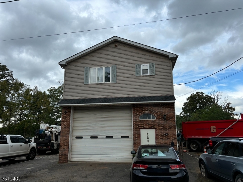 Very sought after property. Not many like this one in Scotch Plains. Excellent conforming industrial yard. 2 Lots 2365 has a free-standing building or Garage 50x23 with over head door and second floor residential apartment .Garage is a flow thru and heated by gas. Front and rear over head garage door, 12 foot. One office in garage..  next door 2369 Waldheim  open lot 70x115 . 2365 and 2369 Waldheim  are being sold together for this purchase price. Lot can store many trucks 10 plus .2 bedroom apartment above garage. Apartment 2nd floor getting 1700 per month tenant pays all utilities except garbage with a month to month lease  but  tenant would like to stay .AC and heat in second floor well kept apartment . Hardwood floors  .