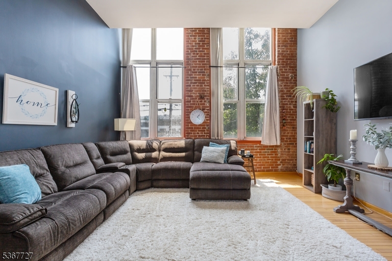 Welcome to 262 Main Street, Unit 203, a stunning 2 Bed, 2 Bath, Corner-unit condominium in the highly sought-after The Mill at Little Falls. Bathed in natural light from dramatic oversized windows, this beautifully maintained home features soaring ceilings, exposed brick accents, gleaming hardwood floors, and an open-concept layout that perfectly blends historic character with modern comfort. The spacious primary suite offers a generous walk-in closet, while the convenience of an in-unit washer and dryer, central air, and a brand-new HVAC system (June 2026) makes everyday living effortless. Life at The Mill extends well beyond your front door. Residents enjoy, a Resort-style outdoor pool, Fitness center, Community room, Tennis courts, Beautiful landscaped grounds with tranquil waterfall views. For commuters, it doesn't get much better. The NYC bus stops just across the street, and the Little Falls train station is only a short walk away, making travel into the city incredibly convenient. This location is close to all major highways, shopping, and plenty of good restaurants!