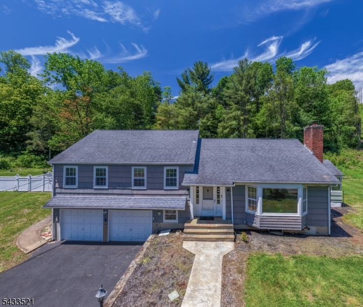 GREAT OPPORTUNITY TO GET INTO CHATHAM ON LARGE PROPERTY W/ AMAZING VIEWS! Here's your chance to create the home of your dreams on almost an acre, perfectly positioned w/ Esternay Field hidden at its back & Passaic River Park across the street, providing gorgeous SE views w/ nothing but trees in either direction. Side split-level home has great flow w/ solid mid-century bones & timeless details like hardwood floors & crown molding throughout highlighted by tons of natural light flowing through abundant windows. Large Living Room w/ big bay window captures serene front vistas & has a wood-burning fireplace. Eat-in Kitchen could be easily combined w/ Dining Room with French doors opening onto expansive wood deck & unused inground pool beyond. Tremendous space & potential to make this Backyard a true resort-like oasis! Enclosed Porch on eastern side of the home could transform into year-round Sunroom/Den w/ windows on 3 sides, perfect for morning coffee in the sun. Upper 2 levels have 4 Bedrooms & 2 Full Baths, including Primary Ensuite. Lower Levels offer Rec/Family Room space & another Full Bath/Laundry Room that would make an excellent Mudroom entrance from the oversized Attached 2-car Garage. Great closet & storage space throughout! Easy access to downtowns/NYC trains in Chatham, Summit & New Providence + the school bus for all highly ranked Chatham schools stop at the end of driveway! Selling strictly AS-IS. Come see the potential before it's gone!