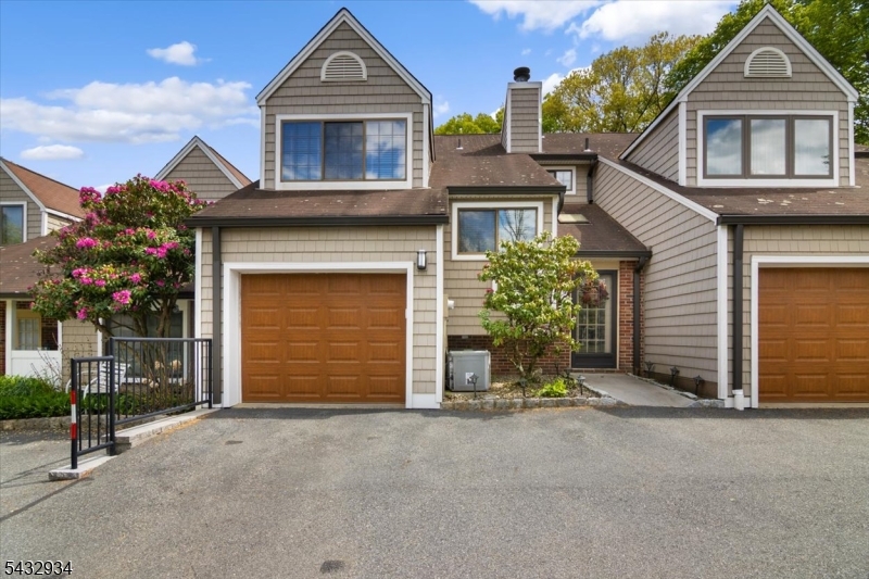 Beautifull 3 bedroom townhome offering spacious versatile living space. Inviting entry with double closet that lead to spacious first floor living space! Oversized kitchen boasts abundant country white cabinetry with side bar & center island offering plenty of granite counter space, all open to Dining Room & Living Room & large window open to Sunroom...  Brand new refrigerator! Living room with high ceilings, includes wood burning fire place & captures additional natural light from 2 story sunroom that incorporates built in bar & cabinets, ceiling fans & dual sliders leading to 2 tiered deck  & side patio area.  Main level also includes laundry room, powder room & garage access, Primary suite features custom organized walk-in closet plus full updated bath with jetted tub & linen closet... additional 2 bedrooms, one offering built in office space for work at home convenience plus second full bath.. This home offers custom mouldings, trim, tray ceilings, central vac and so much more! Enjoy easy living with nothing to do but move right in! Convenient location!