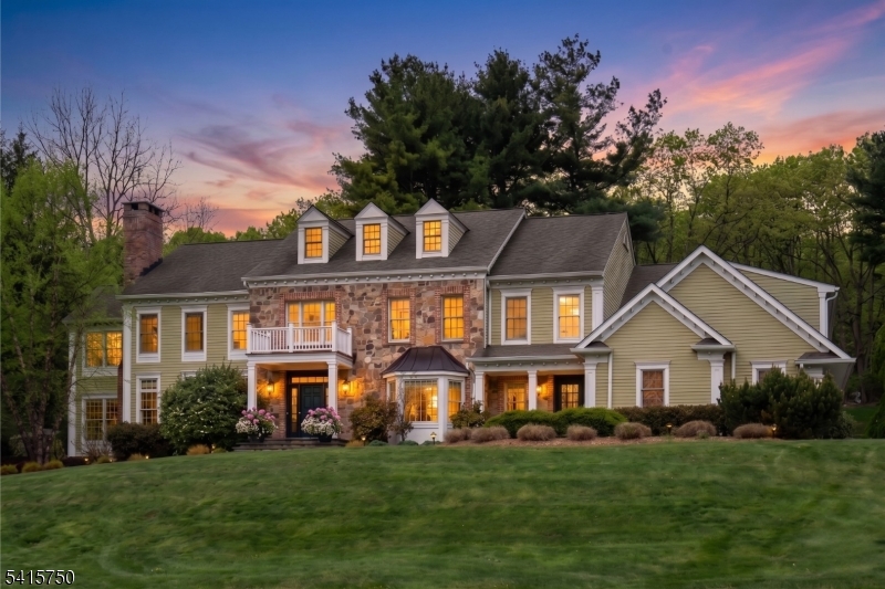 Perched atop 3.16 scenic acres, this distinguished stone and brick estate overlooks a tranquil spring-fed pond, offering privacy, natural beauty, and refined living. Built in 2010, the home blends timeless architecture with exceptional craftsmanship and a balance of grand entertaining and comfortable everyday spaces. A two-story foyer opens to elegant formal rooms with detailed millwork, hardwood floors, and abundant light. The great room features a vaulted ceiling and stone fireplace, flowing into a well-appointed kitchen with custom cabinetry, granite countertops, high-end Wolf and Sub-Zero appliances, and a large center island. French doors lead to a rear terrace for seamless indoor-outdoor living. The primary suite offers a sitting room, fireplace, dual walk-in closets, and spa-like bath. Four additional bedrooms and a bonus/media room provide ample space. The finished lower level adds flexibility for recreation, fitness, or work.  Outdoor highlights include expansive lawns, mature landscaping, garden beds, and a brick fireplace. Minutes to town, transit, and NYC. Chimneys, flues & FP's conveyed "as is" no known issues.