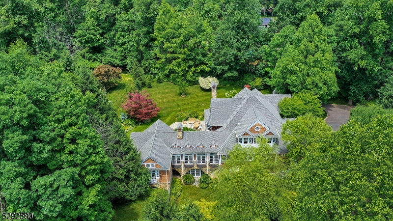 Welcome to an architectural masterpiece of 6720 sq ft on a quiet cul de sac of distinguished homes in the esteemed Watchung Boro. The majestic home set on 1.3 acres of design winning landscape, has been meticulously designed, ideal for entertainment and relaxation. The home is a tranquil retreat with breathtaking views of the garden from every room with multiple balconies. This stunning cedar shake residence by renowned Hiland HallTurner Architects is a class of its own. Enter in through a pair of mahogany glass entry doors, featuring 5 Bedrooms, 5.1 Baths into an open living room with gas fireplace overlooking the lush lawns. The kitchen in the center of the home features high end finishes & appliances, is truly a chef's delight. The Aspen inspired family room boasts of barnwood floors, vaulted pine ceilings, and a floor-to-ceiling 16' stone fireplace. A first-floor primary suite features radiant floor heating, a luxurious spa/bath and his & her walk in closets. The home also features a first floor in law suite with an attached full bath. An office with built in cabinets overlooking the beautiful garden makes work from home a pleasure.The second floor is complete with 2 bedrooms ,2 full baths, a loft and a walk up attic.The backyard is an oasis of lush greens and flowers with an outdoor barbeque grill. The fully finished walkout basement offers a full bath,gym and multiple home office spaces. Convenient access to NYC, shopping, public & private schools ,Summit train station.