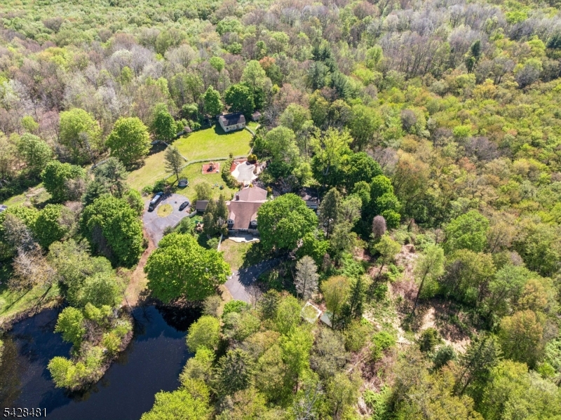 Nestled on approximately 7 private acres, this one-of-a-kind retreat offers the perfect blend of space, character, and natural beauty. Set among a scenic landscape with its own pond, this expansive home delivers over 4,000 square feet of living space designed for those seeking privacy, flexibility, and a true escape from the ordinary. Located just minutes from the area?s popular lakes and nearby state park trails, the property offers year-round opportunities for boating, fishing, hiking, kayaking, and enjoying the outdoors while still remaining conveniently accessible to major routes, shopping, and dining.Inside, the home features generously sized rooms, soaring spaces filled with natural light, and endless possibilities for customization. Whether you envision a private country estate, weekend retreat or an entertainer?s paradise, this property provides the canvas to make it your own.The picturesque grounds create a setting rarely found in today?s market complete with peaceful water views, open green space, and the tranquility buyers dream about. A unique opportunity for those who appreciate nature, privacy, and a property with true presence.