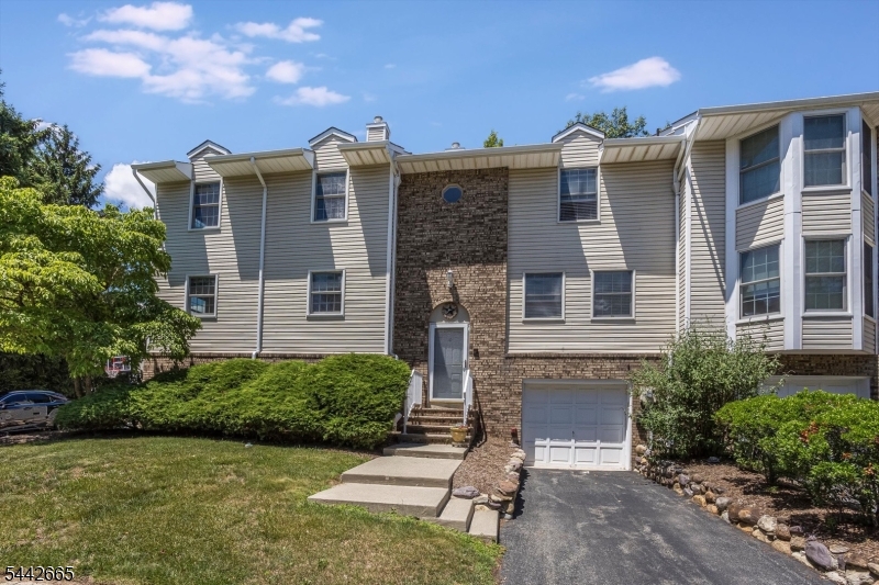 Welcome to Brookstone Circle, a beautifully maintained & tastefully updated three-level townhouse offering two bedrooms, one full bath & two half baths in the highly desirable Brookstone community of Morris Plains/Parsippany. This move-in-ready home features neutral finishes, a practical open-concept layout &hardwood flooring with decorative crown molding throughout, creating a warm and inviting atmosphere for comfortable living. Main level boasts a formal living room and dining room, as well as an eat-in kitchen with granite countertops & a tiled backsplash.Two decks, one off the living room &  another off the primary bedroom, overlook a private backyard, providing wonderful outdoor spaces for relaxation or entertaining. The spacious primary bedroom includes a generous walk-in closet, while the second bedroom is perfect for guests or a home office. The main bath is appointed with marble floors, a Kohler whirlpool tub & a skylight for added natural light. Finished, walk-out ground level offers a family room &a second half bath, making it an ideal flexible space for an office, gym, or recreation room. Floored Attic also.  Additional conveniences include an attached one-car garage, a private driveway, and ample guest parking. This ideal home is close to Routes 53, 80, 287 & 10,  & is just minutes from the downtown areas of Morristown, Denville & Morris Plains, as well as the Denville & Morris Plains train stations with NYC Midtown transit access.