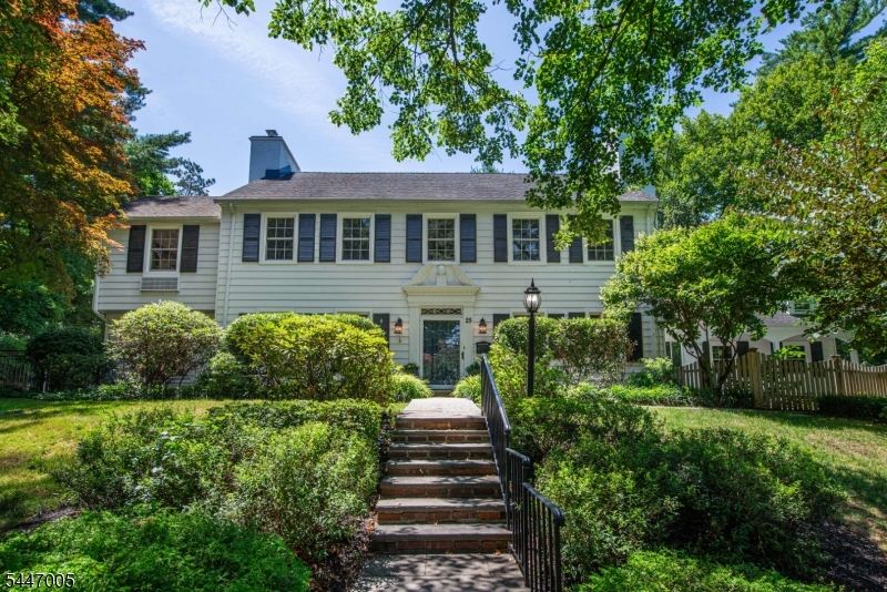 A rare opportunity to own a distinguished Center Hall Colonial in one of Short Hills' most desirable neighborhoods. This elegant residence blends timeless architecture with thoughtful modern updates. Rich in character, the home showcases refinished hardwood floors, graceful archways, detailed moldings, and five fireplaces. The first level features formal living and dining rooms with built-ins, a renovated sunroom with wine cooler, a refreshed gourmet kitchen with center island and premium appliances, mudroom, plus an updated office and powder room. The luxurious primary suite offers a fireplace, professionally designed walk-in closet, and spa-inspired bath. Three additional bedrooms, including one with a private bath ideal for guests, complete the second level. The third floor features another bedroom with a full bath. The finished lower level provides exceptional additional living space. Updates include numerous new plumbing and lighting fixtures, updated baths, the majority of the windows replaced with Pella windows, and a roof approximately five years old. A spacious two-car garage, large driveway, Generac generator, and gas line for a grill add everyday convenience. Set on nearly one-half acre of beautifully landscaped grounds with multiple patios, this exceptional home is just moments from Short Hills Village, The Mall at Short Hills, dining, golf clubs, parks, major highways, NYC train, and the nationally acclaimed Millburn-Short Hills School District.
