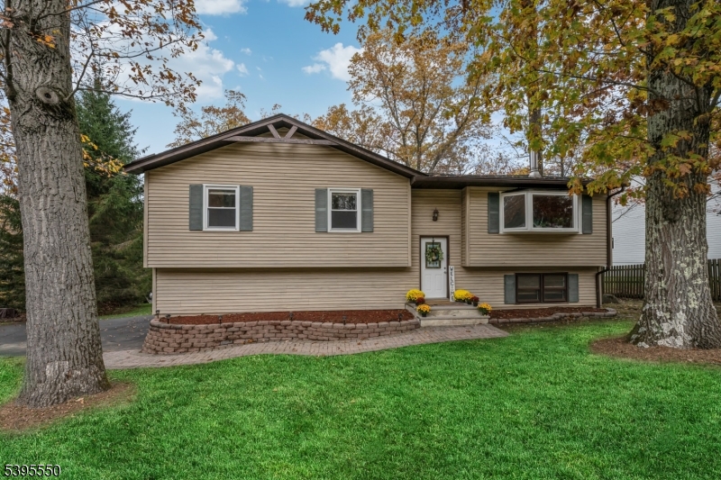 Located in highly sought-after Randolph, known for its top-rated schools, scenic parks, and welcoming community, this beautifully updated home offers comfort, space, and convenience. Set on over an acre with a spacious backyard, it provides an ideal setting for entertaining, recreation, and everyday enjoyment, just minutes from downtown Morristown and major highways.Designed for easy two-level living, the open floor plan is filled with natural light and timeless finishes. The spacious living room features a large picture window and flows seamlessly into the dining room, where a sliding glass door opens to the deck for outdoor dining and entertaining. Cathedral ceilings, mahogany hardwood floors, and an updated kitchen with stainless steel appliances, granite countertops, custom tile backsplash, and rich wood cabinetry add warmth and style.The home offers three bedrooms and two updated full baths, including a primary suite with peaceful views and a private en-suite bath. The lower level features a brick fireplace and flexible living space ideal for a family room, home office, gym, playroom, or guest accommodations, with excellent in-law suite potential. An oversized two-car garage and ground-level patio add convenience.Enjoy your private backyard retreat featuring a spacious deck, patio, and natural surroundings. Located near Shongum Lake in one of Randolph's most desirable neighborhoods, this home offers the space, privacy, and lifestyle you've been searching for.