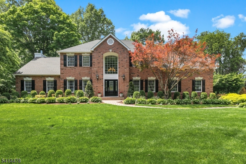 Set on a quiet Basking Ridge cul-de-sac, this exceptional 5-bedroom, 3.5-bath center hall Colonial offers a refined blend of luxury, comfort, and resort-style living. The backyard delivers a breathtaking, private oasis. Lush, meticulously landscaped grounds and vibrant perennial gardens frame a heated gunite pool, expansive deck, bluestone patio, and a covered outdoor kitchen. A  stone fireplace and separate firepit area complete the spectacular setting. A light-filled interior with 9-foot ceilings, custom millwork and rich hardwood floors create an airy, elevated ambiance throughout the main level, which includes a formal living, dining room and an elegant private office. The well-appointed kitchen"featuring granite countertops, a center island and walk-in pantry"opens to the large breakfast room which flows naturally into the spacious family room with a striking fieldstone fireplace. Impressive ten-foot bypass French doors make indoor-outdoor entertaining a breeze. Upstairs, the luxurious primary suite serves as a peaceful retreat with a tray ceiling, large walk-in closet, and spa-like bath. Four additional bedrooms complete this level, including one private en-suite. The finished lower level offers versatility with soaring ceilings and room for recreation, fitness, media, and more. Additional features: extra-height three-car garage, whole-house Generac generator, new roof (2026). Enjoy nationally ranked schools, plus easy access to dining, shopping, highways, and transit.