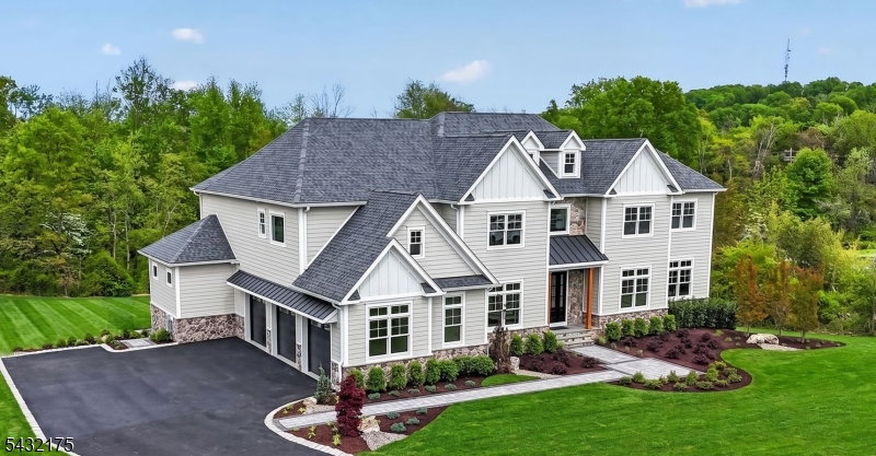 Designed for both comfort and sophistication offering over 7,000 sq. ft. of finished living space across three levels on a sprawling 4.38-acre property, the home features 6 bedrooms and 7.5 bathrooms, along with a private office and two laundry rooms. The grand two-story foyer leads to open, airy living spaces with 10-foot ceilings on the main level and custom architectural details throughout, including coffered ceilings, crown molding, and wainscoting. The chef's kitchen is a showstopper, complete with quartz countertops, a waterfall island, premium stainless steel appliances, a wet bar with wine cooler, and custom cabinetry. The family room offers a cozy gas fireplace with a custom stone surround, while integrated speakers enhance the main living areas.Upstairs, the luxurious primary suite features a tray ceiling and a spa-like bathroom with a freestanding soaking tub, custom shower, and high-end finishes.The finished walk-out basement expands your living space with a bedroom, full bathroom, bonus room, and luxury vinyl plank flooring ideal for guests, recreation, or a private suite.This home showcases timeless curb appeal, a striking two-story entry fa ade accented by natural stone. Enjoy a beautifully designed outdoor setting featuring a paver walkway, patio, and expansive rear deck perfect for entertaining. The professionally landscaped grounds include a sprinkler system, lush front sod.
