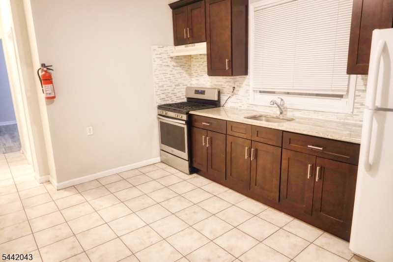 Exceptional opportunity to own a well-maintained two-family In Newark. This pristine investment features two spacious units, each offering 3 bedrooms and 1 full bath with eat in kitchens and ideal for owner-occupants or investors alike. The finished basement adds tremendous value, featuring a comfortable lounge area and two additional rooms that provide flexible space for recreation, home offices, storage, or extended living needs. Both units also each feature a bonus sun filled room.Positioned directly across from Weequahic Park, residents enjoy beautiful green space, walking trails, recreational amenities, and scenic views right outside their door. Commuters will appreciate the direct NYC bus access and Newark Penn Station in close proximity.With major economic development underway nearby, including Lionsgate's planned film and television production complex, the area is poised for continued growth and increased demand. Whether you're looking to generate strong rental income or occupy one unit while renting the other, this property presents an outstanding investment opportunity in a rapidly evolving neighborhood.