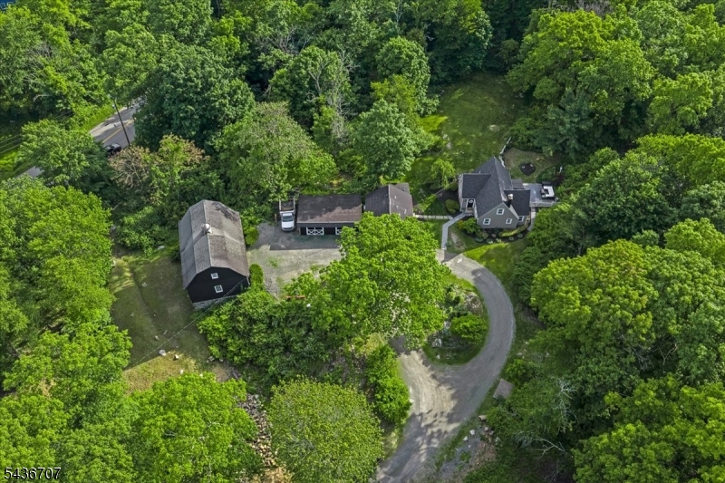 Escape to your own private retreat nestled on a 5.5 acre picturesque wooded lot that offers the perfect blend of comfort, functionality and country living. The immaculate main home features 3 bedrooms and 2 full bathrooms with inviting living spaces full of warmth and character. The property is truly one of a kind, offering an impressive detached outbuilding complete with a spacious great room and full bathroom-ideal for entertaining, guest accommodations, home office or creative studio space. Car enthusiasts, hobbyists and those in need of extra space will appreciate the oversized detached garage. The impressive barn offers endless possibility including a basement gym and sauna. Unwind in the hot tub surrounded by nature after a fun day on the property's quad trails. This one of a kind property combines the charm of country living with amenities designed for today's lifestyle.