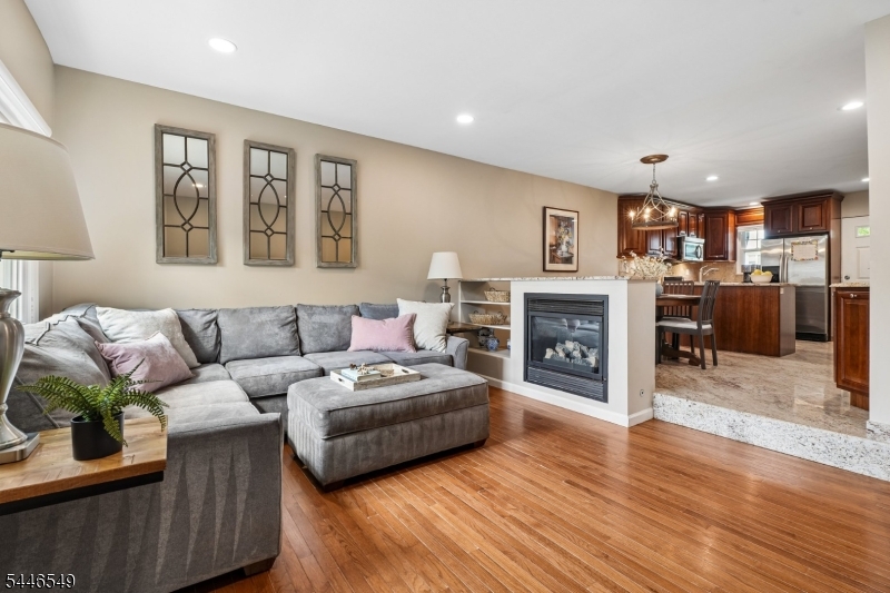 Enjoy the comfort and convenience of townhouse-style living in this updated end-unit condo, ideally located just moments from downtown Westfield, shopping, dining, parks, and NYC transportation. A private entrance welcomes you into the open main level, where the kitchen features granite countertops, stainless steel appliances, and overlooks the dining and living areas. A gas fireplace creates a warm focal point between the living and dining spaces, while a convenient powder room completes the first floor. Upstairs, you'll find two comfortable bedrooms with ample closet space, along with a full bath featuring a spacious granite vanity and oversized shower. Second-floor laundry adds everyday convenience. The finished lower level offers great bonus space plus plenty of storage. Additional highlights include central air conditioning, replacement windows (2019), a new hot water heater (2025), off-street parking and private rear entrance. All of this in an exceptionally convenient Westfield location, offering low-maintenance living just minutes from everything downtown has to offer.