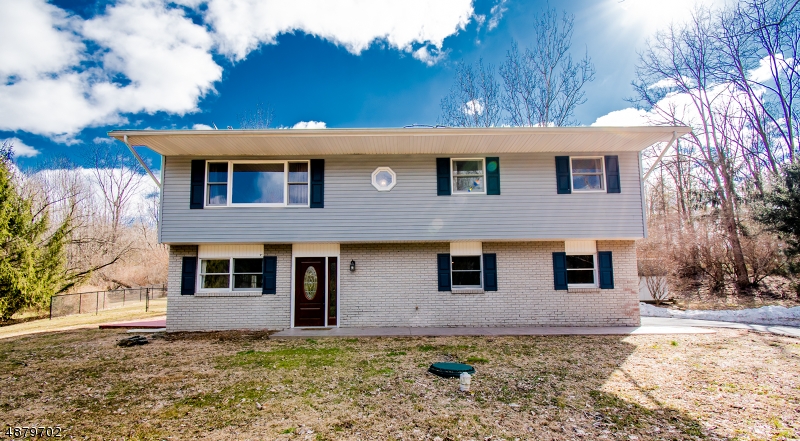 Welcome to this spacious, turnkey bi-level home that features an open floor plan, elegant and updated kitchen, multiple decks and a large, private, fenced back yard lined with evergreens. This is where comfort, convenience and country living meet! Minutes from Rt. 80, this home was completely renovated in 2014.  The kitchen features beautiful cabinetry, granite counters, stainless appliances and an open design that flows into the dining room and living room.  Step out the glass door in the kitchen onto the massive rear deck for ease of entertaining and enjoying the serene and private back yard.  On the first level you have a large tiled front entrance foyer, interior garage entrance, laundry and utilities and the spacious den and family room with separate deck and half bath.  See it today!